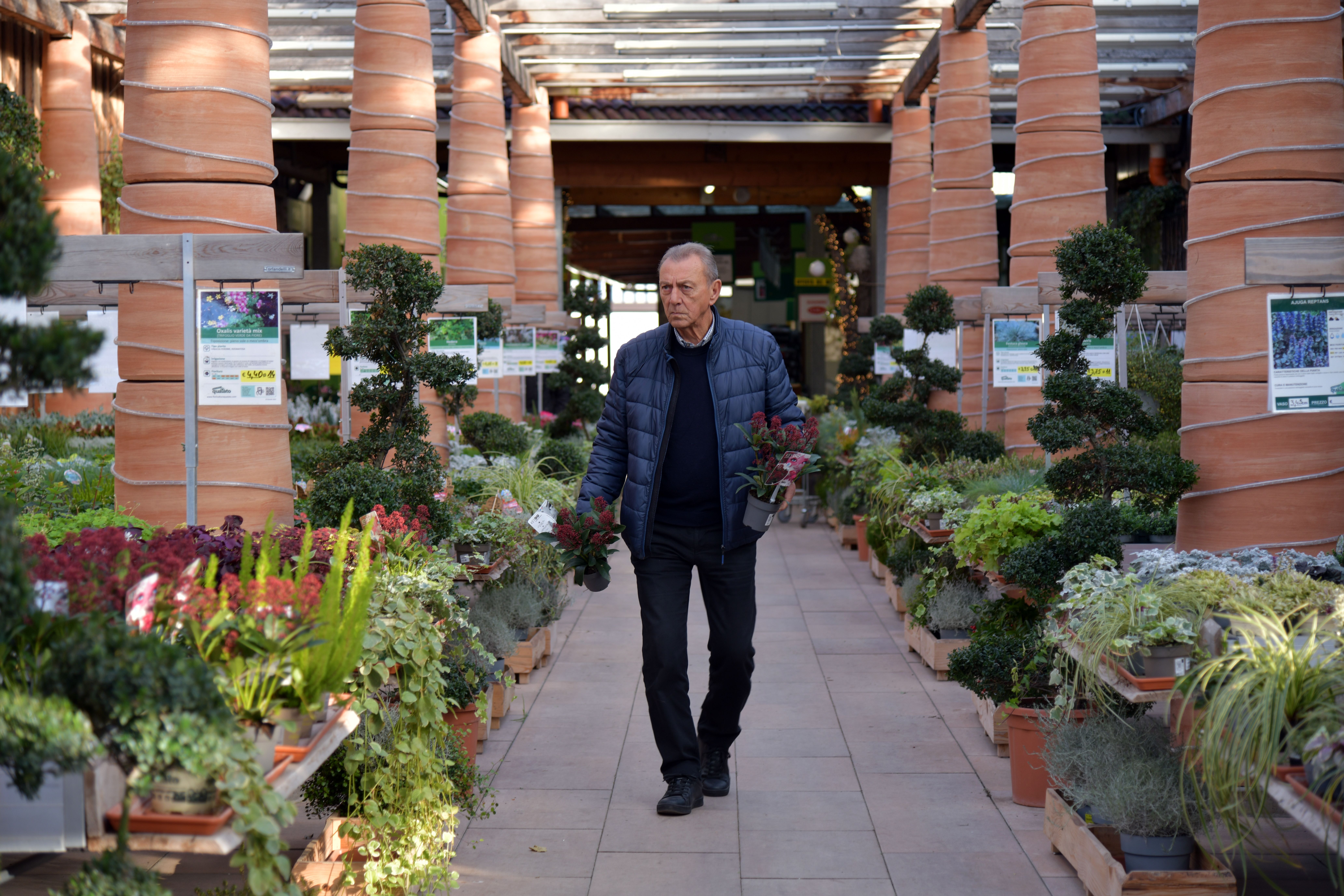 man walking through garden centre 
